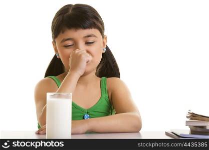 Girl fussing over a glass of milk