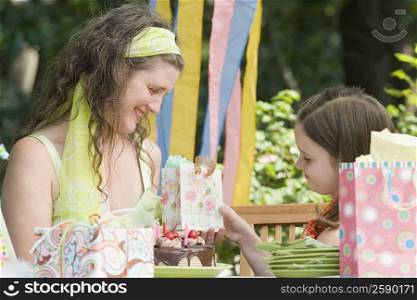 Girl giving a gift to her mother on her birthday