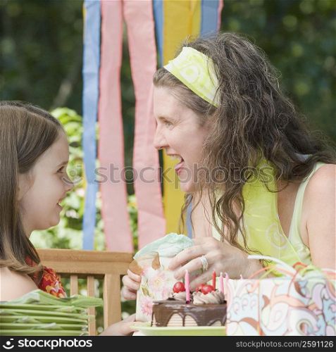 Girl giving a gift to her mother on her birthday