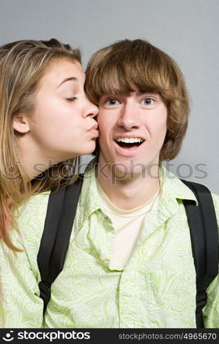 Girl giving boy a kiss on the cheek