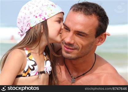 Girl giving dad a kiss