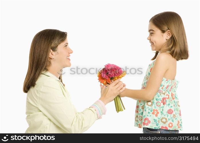 Girl giving mother bouquet of flowers.