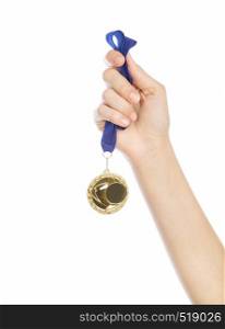 Girl hand raised holding gold medal against white background award and victory concept