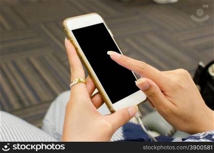 Girl hand touching screen on modern mobile smart phone