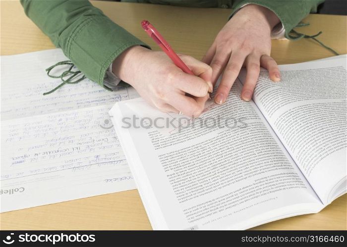 Girl hands writing a little note during class