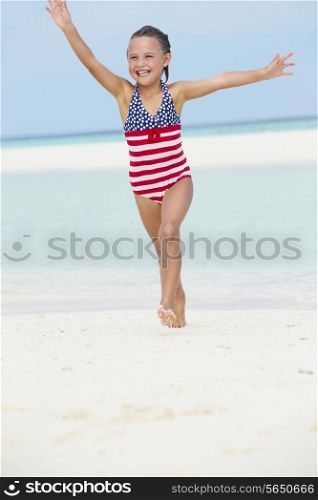 Girl Having Fun In Sea On Beach Holiday