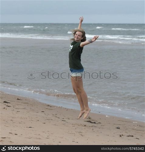 Girl having fun on the beach, York Point, Prince Edward Island, Canada