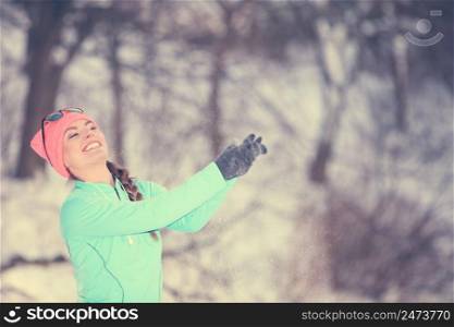 Girl having fun with snow in park. Lady playing in winter season. Health nature entertainment fashion concept. . Girl having fun with snow.