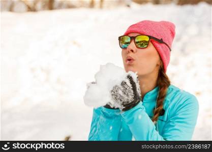 Girl having fun with snow. Winter park relax entertaiment fitness. Health nature fashion concept. . Girl having fun with snow