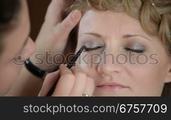girl having makeup applied