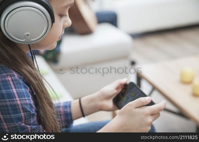 girl headphones playing games smartphone