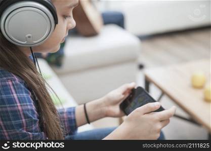 girl headphones playing games smartphone