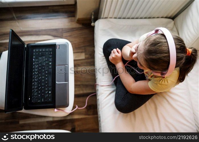 girl headphones wathcing movie laptop