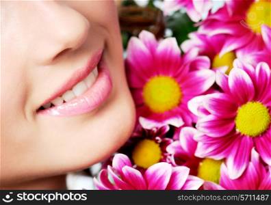 girl healthy smile with pink chrysanthemum on a background