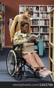girl helping her colleague wheelchair choose book project 4