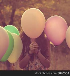 Girl hiding behind the balloon
