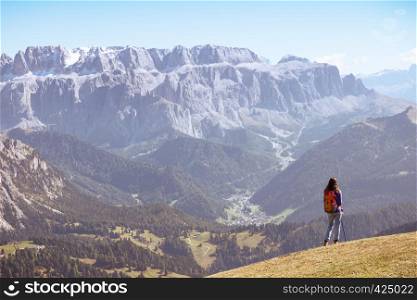 girl hiker at the mountains Dolomites and views of the valley, Italy. Seceda