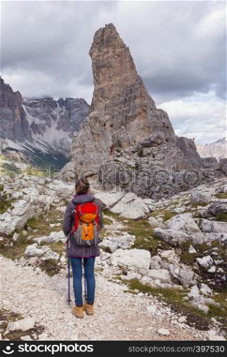 girl hiker at the mountains Dolomites, Italy. Cinque Torri