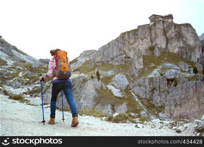girl hiker at the mountains Dolomites, view of the Rifugio Vajolet, Pozza Di Fassa, Italy