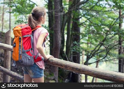 girl hiker on a path at the forest