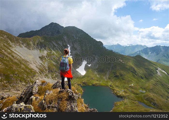 girl hiker on a path at the mountains. Transfogaras. Romania