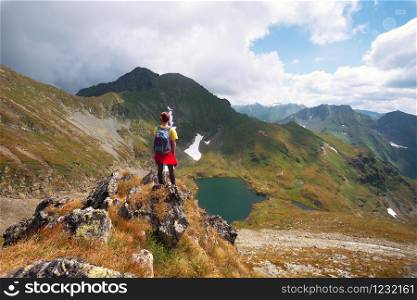 girl hiker on a path at the mountains. Transfogaras. Romania