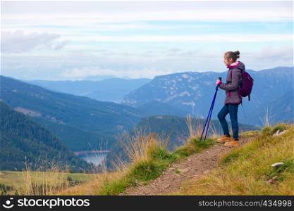 girl hiker on a trail at the Dolomites mountains