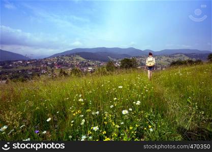 girl hiker with a backpack walking in the mountains. Vorokhta - Ukrainian landscape.