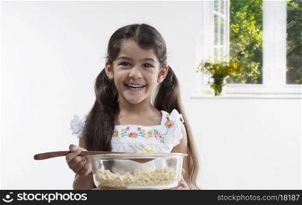 Girl holding a bowl and spatula