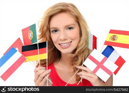girl holding a bunch of national flags