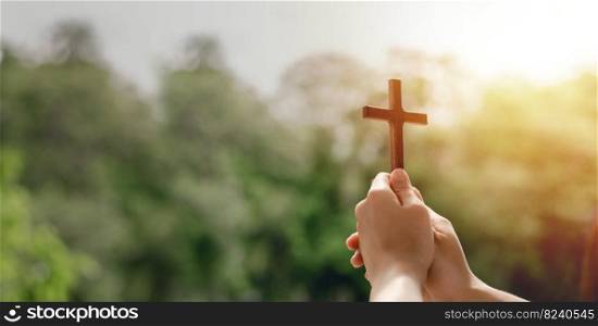 girl holding a cross to pray thank god Praise the Lord with outdoor background, pray, easter and good holidays concept