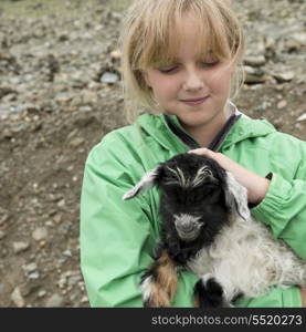 Girl holding a lamb, Nagarze, Shannan, Tibet, China