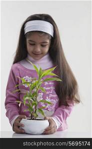 Girl holding a potted plant