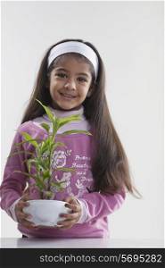 Girl holding a potted plant