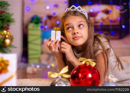 Girl holding a small pretty gift in her hands