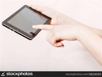 girl holding and clicking tablet-pc screen on pink background