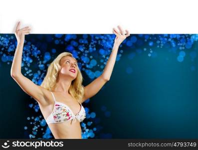 Girl holding banner. Young girl in white bikini with blank banner. Place for text