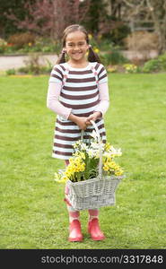 Girl Holding Basket Of Daffodils In Garden