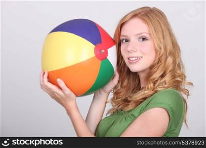 Girl holding beach ball