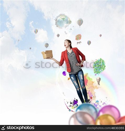 Girl holding box in hand. Happy young woman in red jacket opening gift box. Elements of this image are furnished by NASA