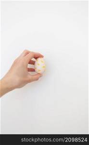 Girl holding Easter egg painted with watercolors in her hands, isolated on white background. Girl holding Easter egg painted with watercolors in her hands, isolated on white background.