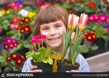 Girl holding flower pots, portrait