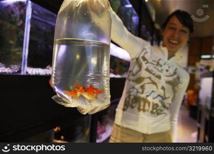 Girl Holding Goldfish in a Bag