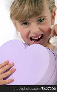 Girl holding heart-shaped box