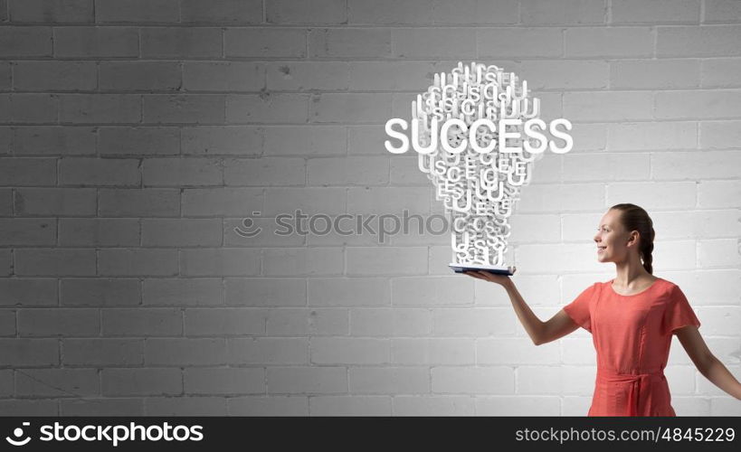 Girl holding opened book. Young woman in red dress with opened book in hand