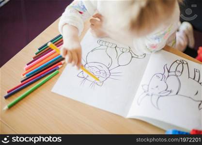 girl holding pencil sitting table. High resolution photo. girl holding pencil sitting table. High quality photo