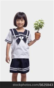 Girl Holding Potted Plant