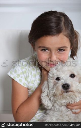 Girl holding small dog