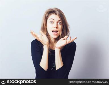 girl holding something in his hand. Isolated on gray background