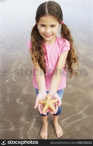 Girl Holding Starfish Found On Beach